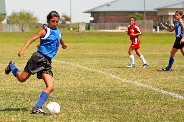 U12G Blue Angels defender sending the ball